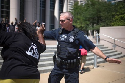 policeman tries to block activist